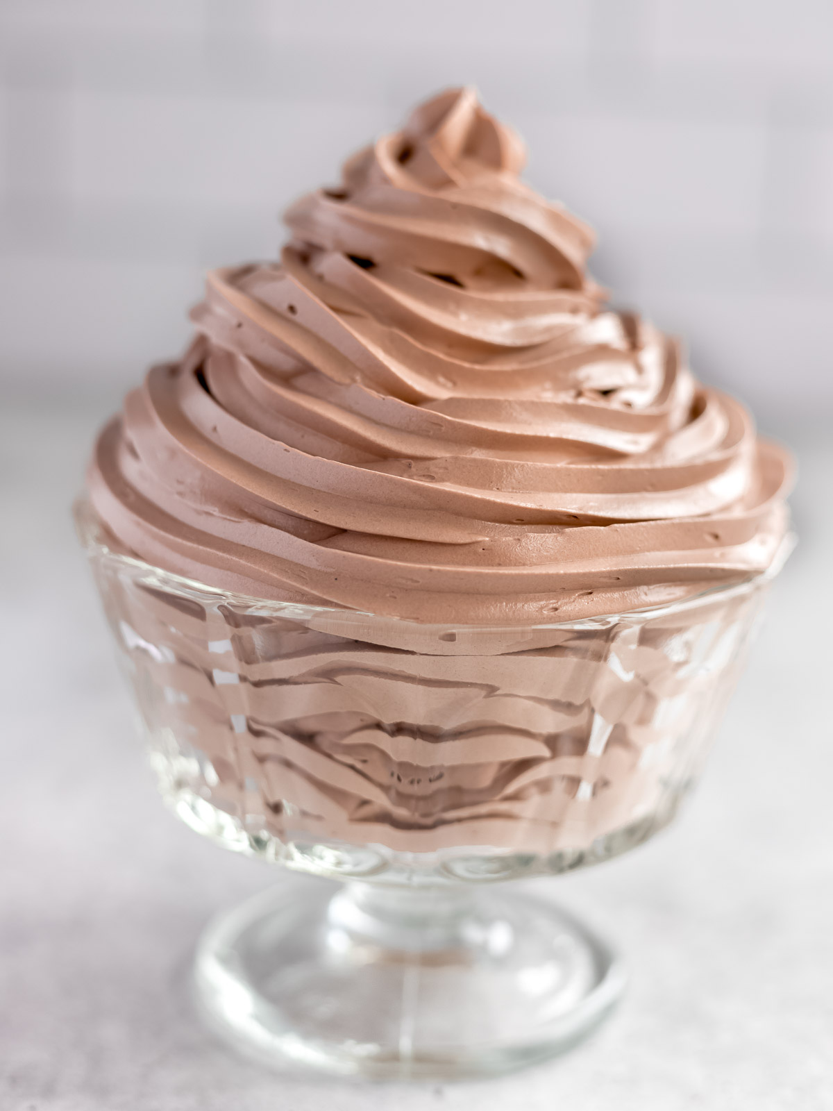 Silky smooth chocolate Swiss meringue buttercream, piped into a glass jar.