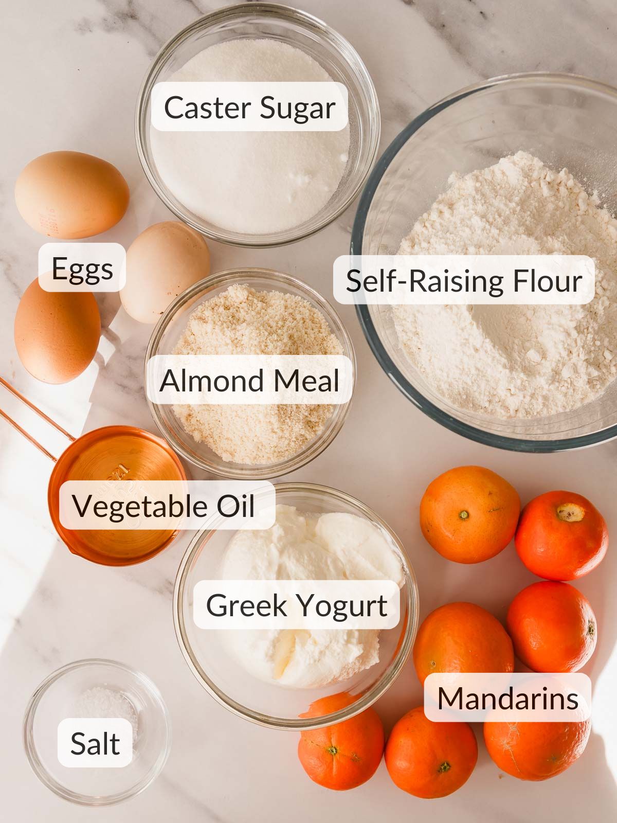 Ingredients needed to make a mandarin almond cake.