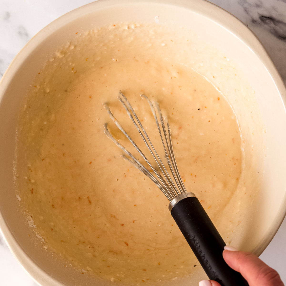 Adding the dry ingredients to the wet mix.
