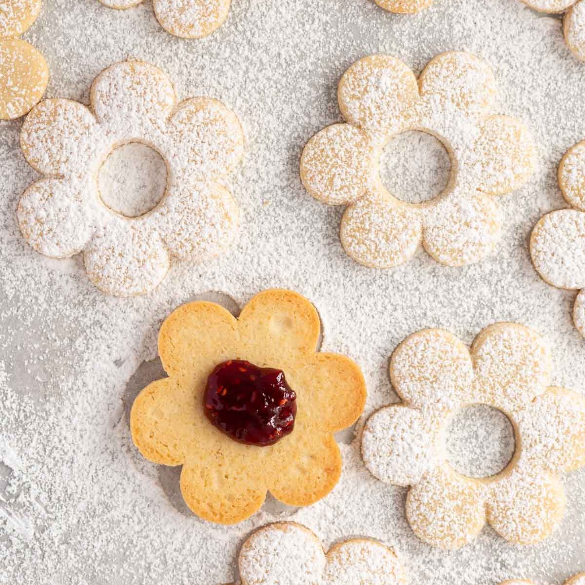 Place a teaspoon of jam in the centre of each bottom cookie.