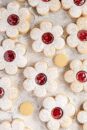 Jam-filled Linzer cookies, with cut out shapes.
