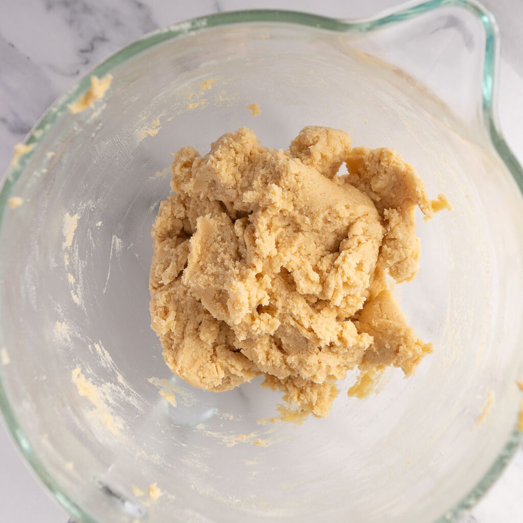 Mixing in the dry ingredients until the mixture just forms a dough.