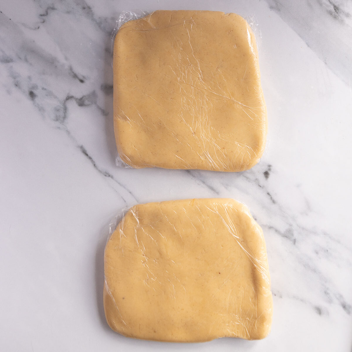 Divide the dough into 2, then wrap and refrigerate.