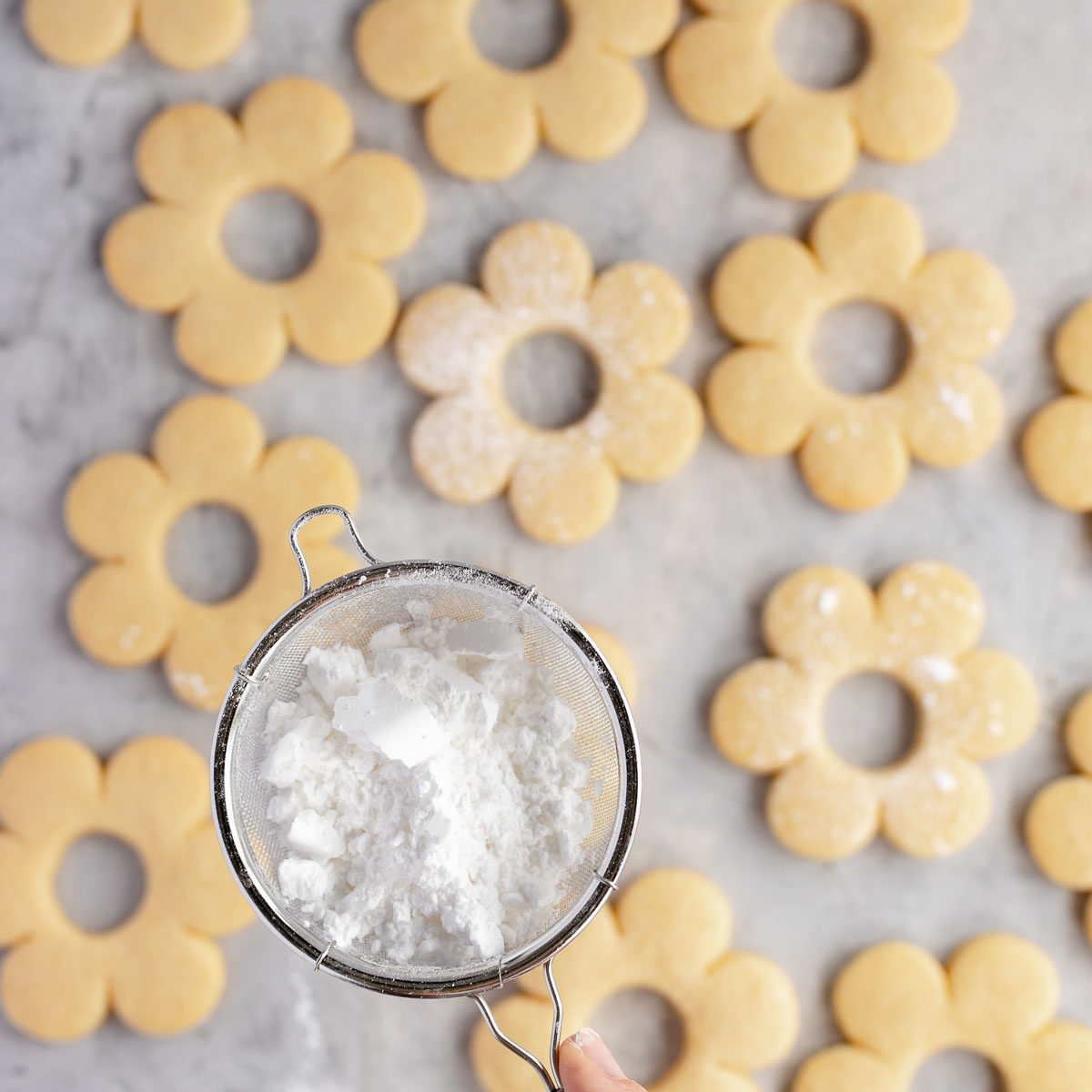 Cookies baked until lightly golden, then dusted with icing sugar.