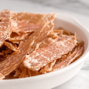 Dehydrated chicken breast strips are healthy, additive-free treats safe for dogs.