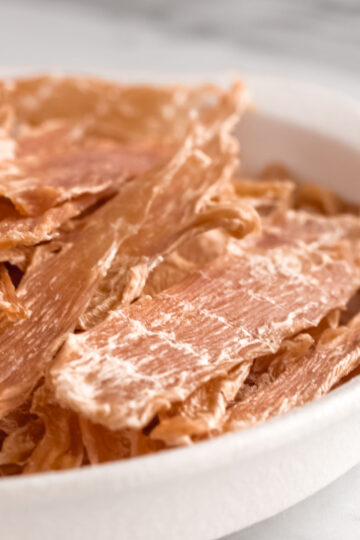 Dehydrated chicken breast strips are healthy, additive-free treats safe for dogs.