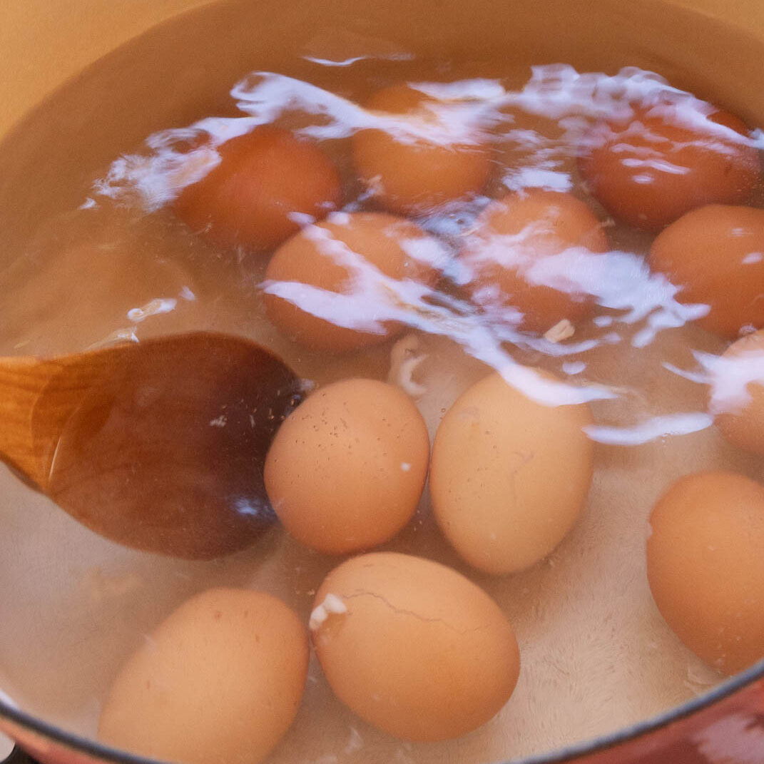 Stirring the eggs as the cook, to keep yolks in the middle of the eggs.