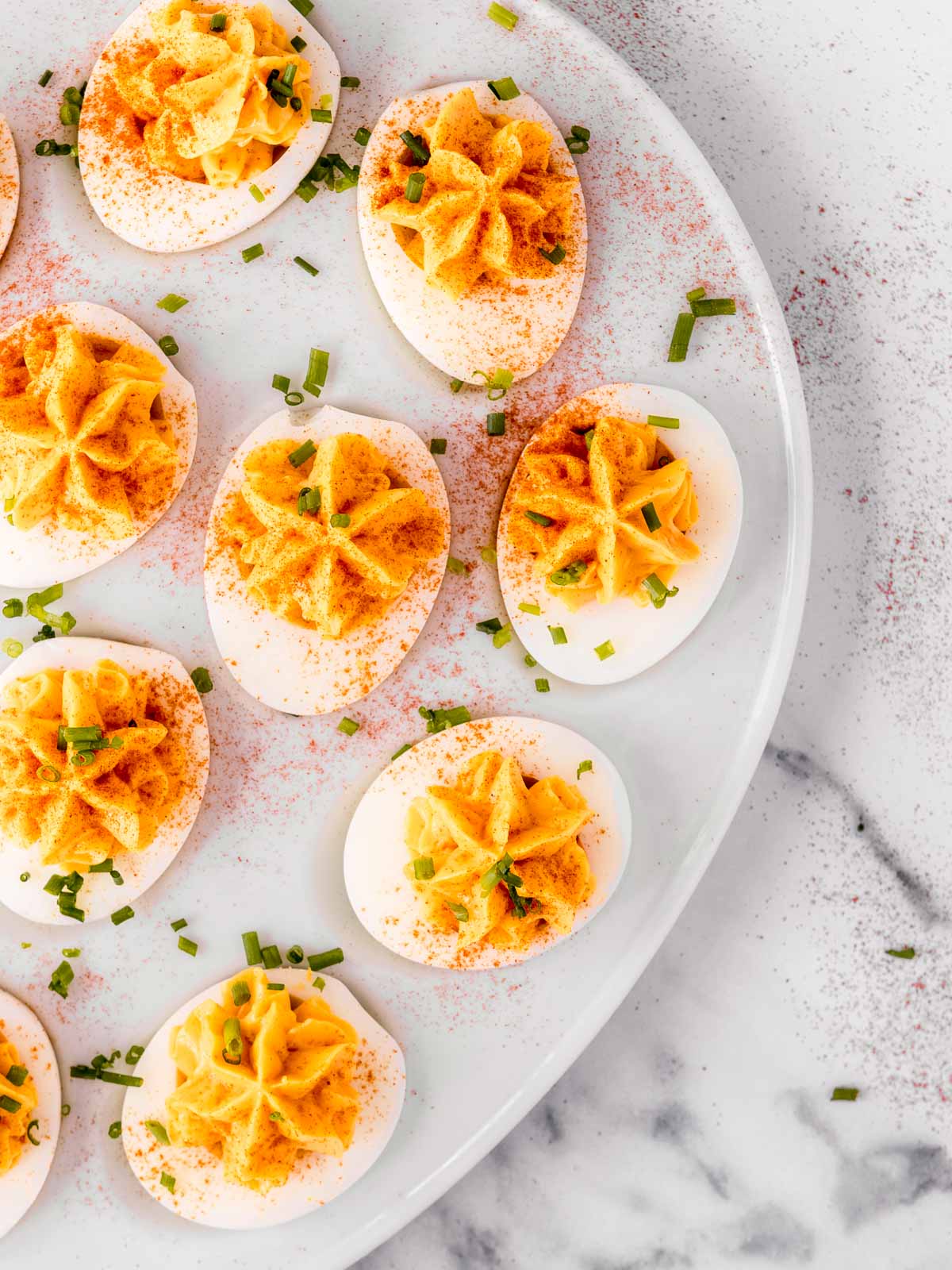 Australian classic party food; curried devilled eggs, sprinkled with paprika and chives.