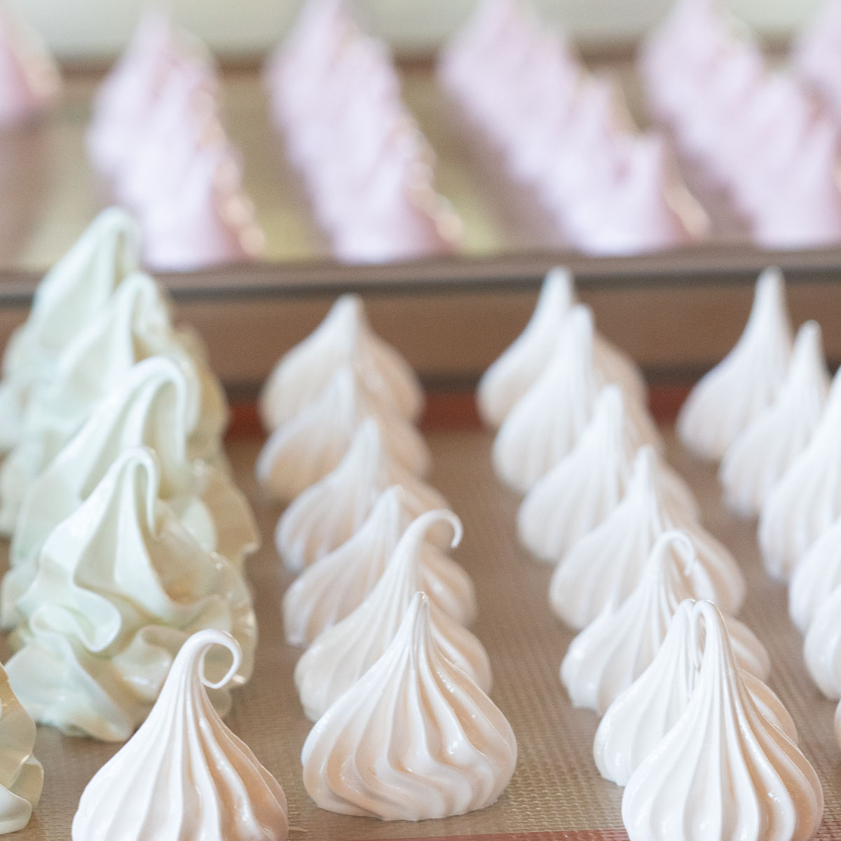 Piped meringue, using different nozzles to create differnet shaped mini meringues.