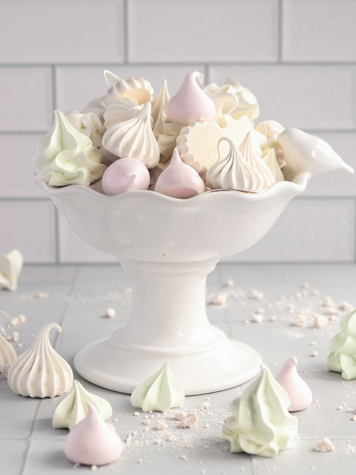 A bowl full of colourful, crispy mini meringues.