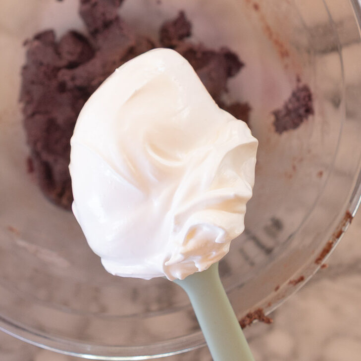 Mixing meringue into the macaron paste.
