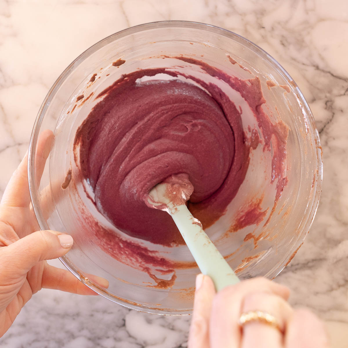 Making red velvet macarons, by mixing in the Italian meringue.
