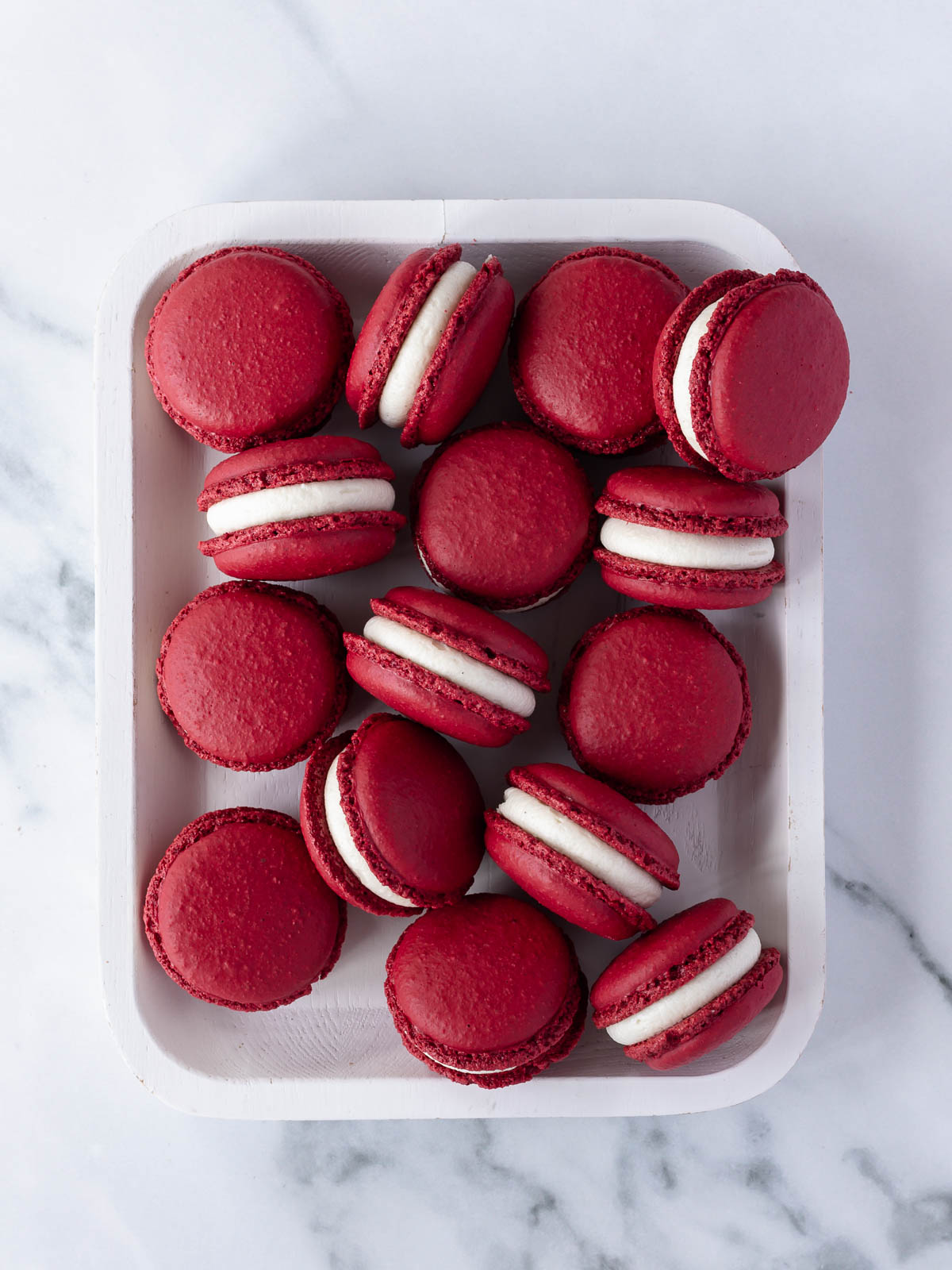 A tray of deep red velvet macarons.