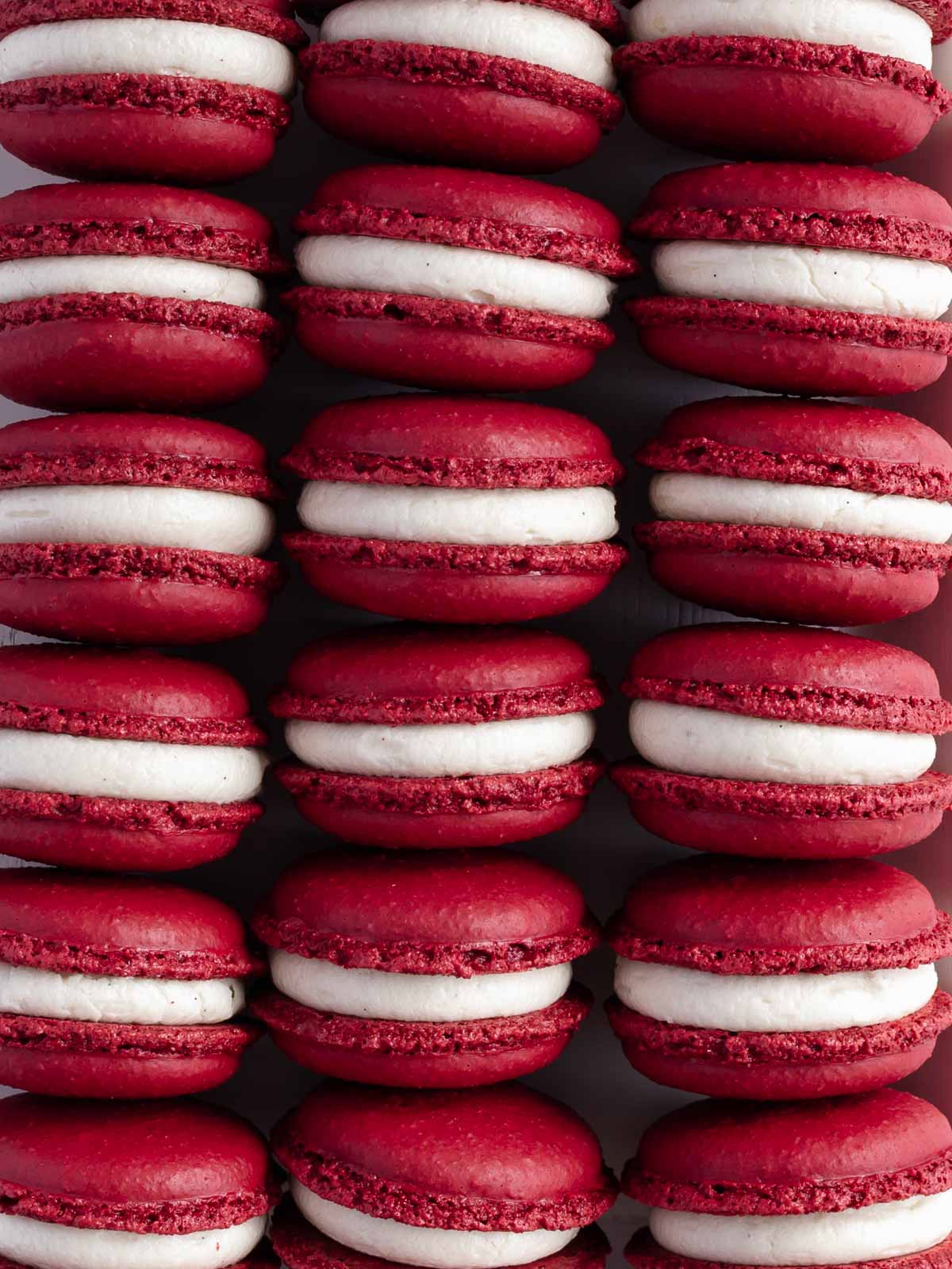 Rows of perfect red velvet macarons.