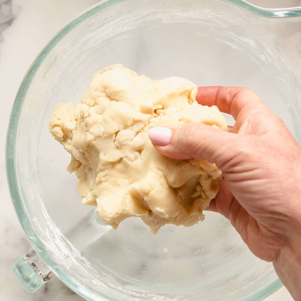 Folding in the dry ingredients to make a firm shortbread dough.