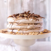 A 3 layered Nutella Pavlova Stack, filled with nutella cream, toasted hazelnuts and dark chocolate.