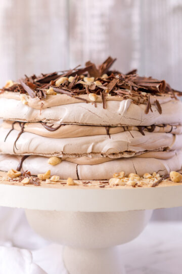 A 3 layered Nutella Pavlova Stack, filled with nutella cream, toasted hazelnuts and dark chocolate.