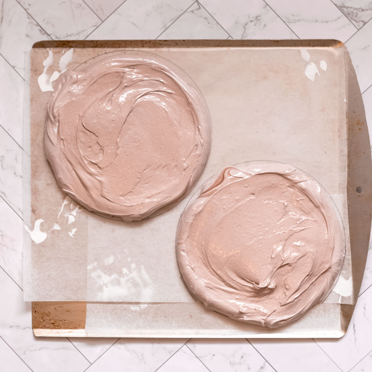 Spreading chocolate pavlova mixture onto a baking tray, to make a nutella pavlova stack.