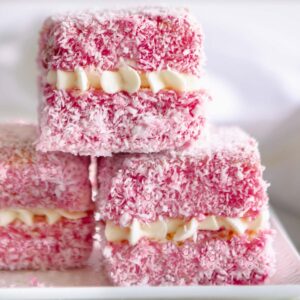 Pink lamingtons filled with chantilly cream.