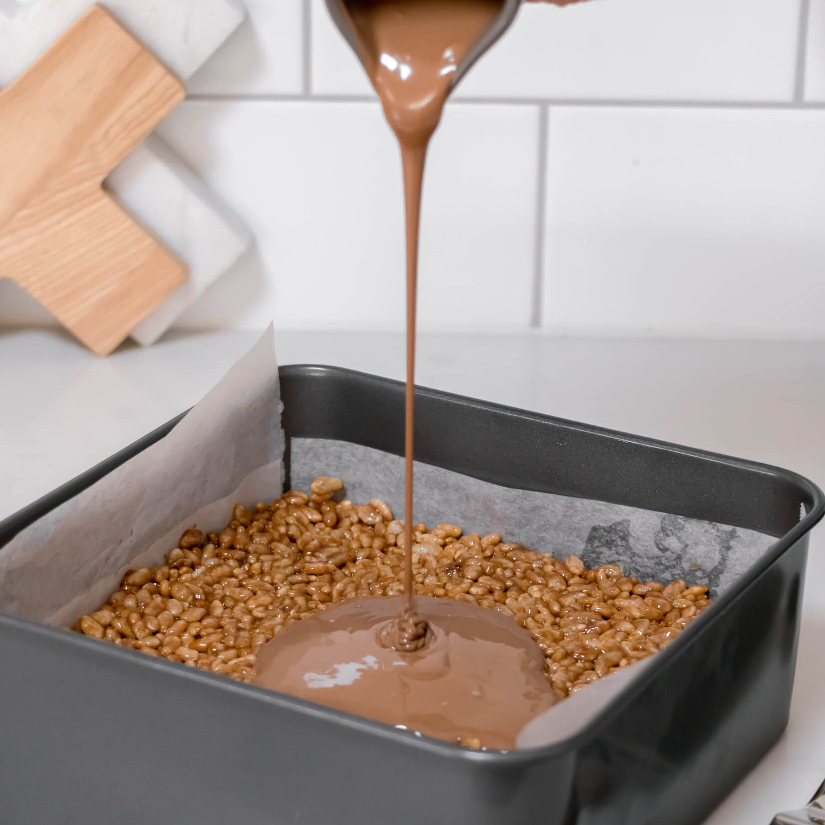 Pour melted chocolate over the top of the Mars Bar slice.
